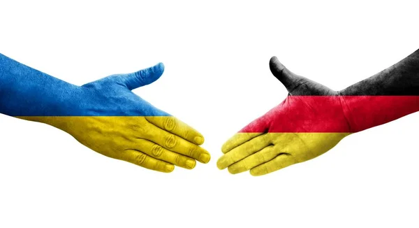 手に描かれたドイツとウクライナの旗の間の握手 隔離された透明画像 — ストック写真