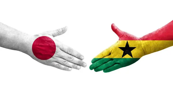 stock image Handshake between Ghana and Japan flags painted on hands, isolated transparent image.