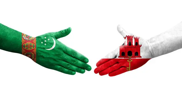 Händedruck Zwischen Flaggen Gibraltars Und Turkmenistans Auf Hände Gemalt Isoliertes — Stockfoto