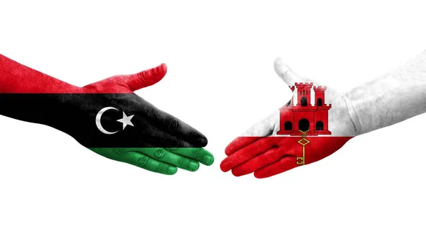 Händedruck Zwischen Gibraltar Und Libyen Flaggen Auf Händen Gemalt Isoliertes — Stockfoto