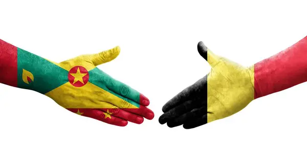 Stock image Handshake between Grenada and Belgium flags painted on hands, isolated transparent image.