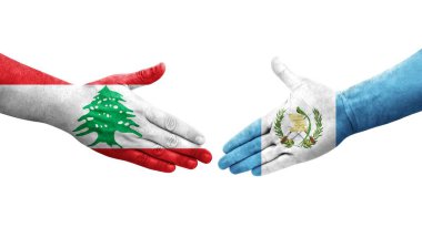 Guatemala ve Lübnan bayrakları arasındaki el sıkışma ellerinde izole şeffaf görüntü.