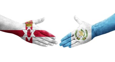 Guatemala ve Kuzey İrlanda bayrakları arasındaki el sıkışma ellerinde resmedilmiş şeffaf görüntü.
