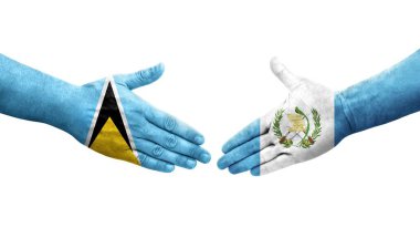 Guatemala ve Saint Lucia bayrakları arasındaki tokalaşma ellerinde izole şeffaf görüntü.