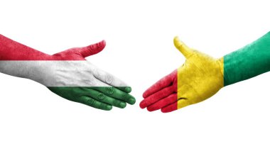 Ellerinde Gine ve Macaristan bayrakları arasında el sıkışma, izole şeffaf görüntü.
