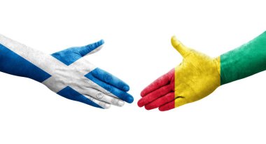 Gine ve İskoçya bayrakları arasındaki el sıkışma ellerinde resmedilmiş şeffaf bir görüntü.