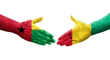 Gine ve Gine Bissau bayrakları arasındaki tokalaşma elleri boyalı, izole şeffaf görüntü.