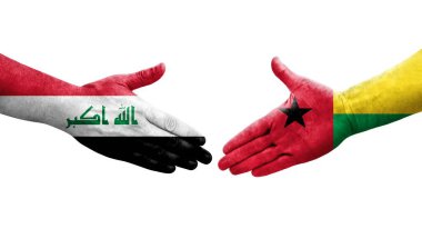 Gine Bissau ve Irak bayrakları arasındaki el sıkışma, izole şeffaf görüntü.