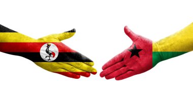 Gine Bissau ve Uganda bayrakları arasındaki el sıkışma, izole şeffaf görüntü.