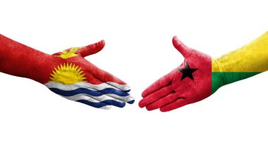 Ellerinde Gine Bissau ve Kiribati bayrakları arasında el sıkışma, izole şeffaf görüntü.