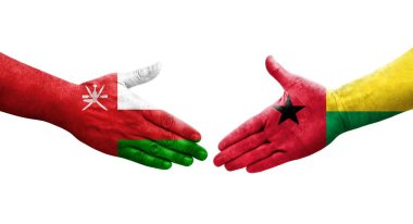 Gine Bissau ve Umman bayrakları arasındaki el sıkışma..