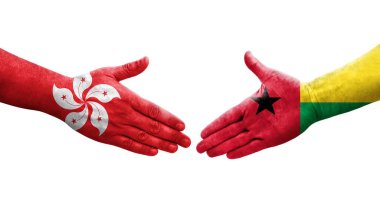 Ellerinde Gine Bissau ve Hong Kong bayrakları arasında el sıkışma, izole şeffaf görüntü.