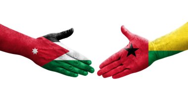Gine Bissau ve Ürdün bayrakları arasındaki el sıkışma ellerinde izole şeffaf görüntü.