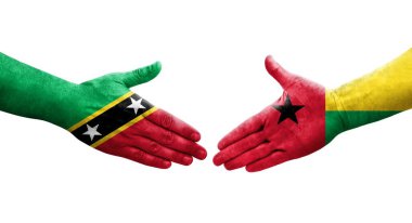 Gine Bissau ile Saint Kitts ve Nevis bayrakları arasındaki el sıkışma..