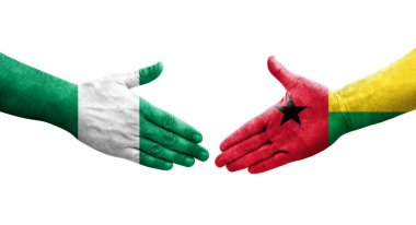 Ellerinde Gine Bissau ve Nijerya bayrakları arasında el sıkışma, izole şeffaf görüntü.
