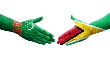 Guyana ve Türkmenistan bayrakları arasındaki el sıkışma, izole şeffaf görüntü.