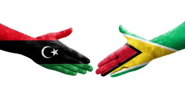Guyana ve Libya bayrakları arasındaki el sıkışma, izole edilmiş şeffaf görüntü.