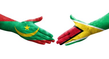 Guyana ve Moritanya bayrakları arasındaki el sıkışma ellerinde izole şeffaf görüntü.