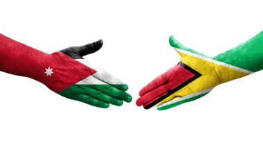 Guyana ve Ürdün bayrakları arasındaki el sıkışma ellere boyanmış, izole şeffaf görüntü.
