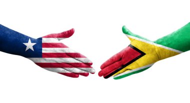 Guyana ve Liberya bayrakları arasındaki el sıkışma ellerinde izole şeffaf görüntü.