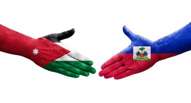 Haiti ve Ürdün bayrakları arasındaki el sıkışma ellere boyanmış, izole şeffaf görüntü.