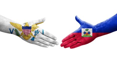 Haiti ve Virgin Adaları arasındaki el sıkışma ellerinde boyanmış bayraklar, yalıtılmış şeffaf görüntü.