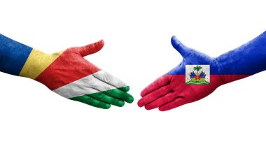 Haiti ve Seyşeller arasındaki el sıkışma ellerinde boyanmış bayraklar, yalıtılmış şeffaf görüntü.