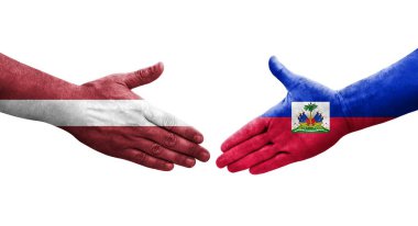 Ellerinde Haiti ve Letonya bayrakları arasında el sıkışma, izole şeffaf görüntü.