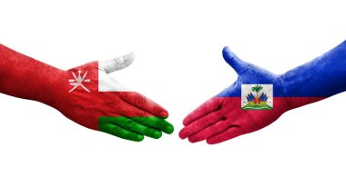 Haiti ve Umman bayrakları arasındaki el sıkışma, izole şeffaf görüntü.