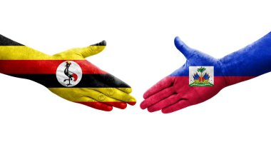 Ellerinde Haiti ve Uganda bayrakları arasında el sıkışma, izole şeffaf görüntü.