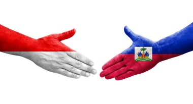 Haiti ve Endonezya bayrakları arasındaki el sıkışma ellerinde resmedilmiş şeffaf görüntü.