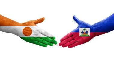 Ellerinde Haiti ve Nijer bayrakları arasında el sıkışma, izole şeffaf görüntü.