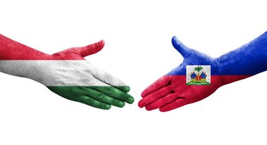 Ellerinde Haiti ve Macaristan bayrakları arasında el sıkışma, izole şeffaf görüntü.