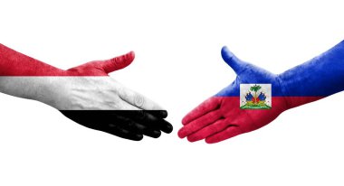 Haiti ve Yemen bayrakları arasındaki el sıkışma ellerinde resmedilmiş şeffaf görüntü.
