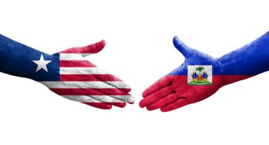 Haiti ve Liberya bayrakları arasındaki el sıkışma, izole şeffaf görüntü.