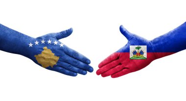 Ellerinde Haiti ve Kosova bayrakları arasında el sıkışma, izole edilmiş şeffaf görüntü.