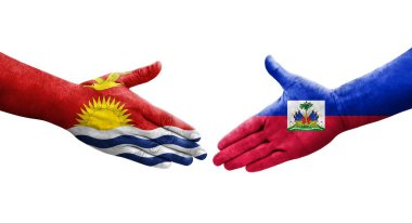 Haiti ve Kiribati bayrakları arasındaki el sıkışma ellerinde resmedilmiş şeffaf görüntü.