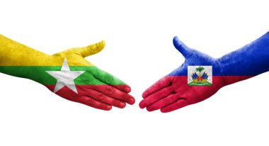 Haiti ve Myanmar bayrakları arasındaki el sıkışma ellerinde resmedilmiş şeffaf görüntü.
