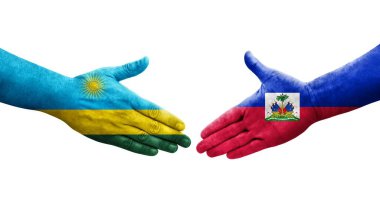 Haiti ve Ruanda bayrakları arasındaki el sıkışma ellerinde resmedilmiş şeffaf görüntü.
