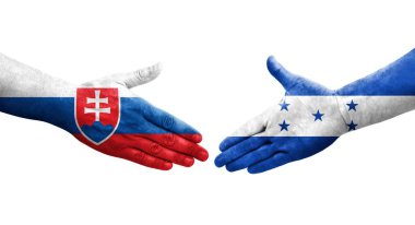 Honduras ve Slovakya bayrakları arasındaki el sıkışma ellerinde boyalı, izole şeffaf görüntü.