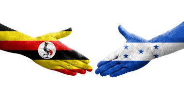 Honduras ve Uganda bayrakları arasında el sıkışma, izole şeffaf görüntü.