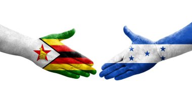 Honduras ve Zimbabwe bayrakları arasındaki el sıkışma ellerinde izole şeffaf görüntü.