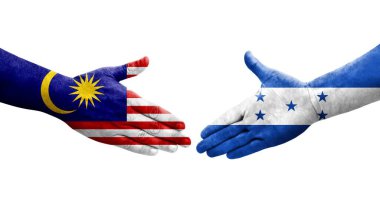 Honduras ve Malezya bayrakları arasındaki el sıkışma ellerinde boyanmış, izole şeffaf görüntü.