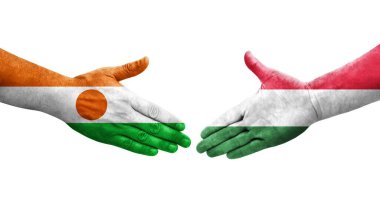 Ellerinde Macaristan ve Nijer bayrakları arasında el sıkışma, izole şeffaf görüntü.