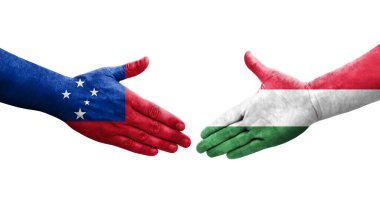 Ellerinde Macaristan ve Samoa bayrakları arasında el sıkışma, izole şeffaf görüntü.