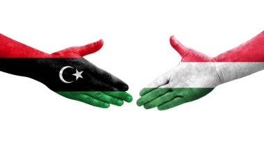 Ellerinde Macaristan ve Libya bayrakları arasında el sıkışma, izole şeffaf görüntü.