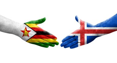 İzlanda ve Zimbabwe bayrakları arasındaki el sıkışma ellerinde izole şeffaf görüntü.