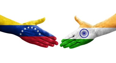 Hindistan ve Venezuela bayrakları arasındaki tokalaşma elleri boyalı, izole şeffaf görüntü.