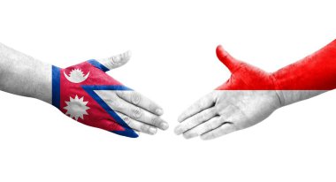 Ellere boyanmış Endonezya ve Nepal bayrakları arasındaki el sıkışma, izole şeffaf görüntü.