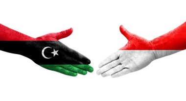 Ellere boyanmış Endonezya ve Libya bayrakları arasındaki el sıkışma, izole şeffaf görüntü.